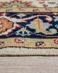 Handcrafted Xena Ivory Hand Knotted Wool Rug, a soft ivory wool rug featuring subtle geometric patterns, partially visible in a bright, airy living room setting.