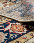 Handcrafted Xena Ivory Hand Knotted Wool Rug, its intricate hand-knotted wool texture and subtle ivory tones lending warmth and sophistication to a bright, modern living room setting with natural light.