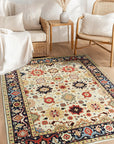Violet Traditional Ivory Hand Knotted Wool Rug, a soft ivory wool rug with intricate traditional patterns, seen in a bright living room setting, lending warmth and elegance to the space.