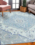 Stylish Trendy Ivory Hand Knotted Wool Rug graces a bright living space, its textured ivory wool complementing a neutral sofa and light wood accents.