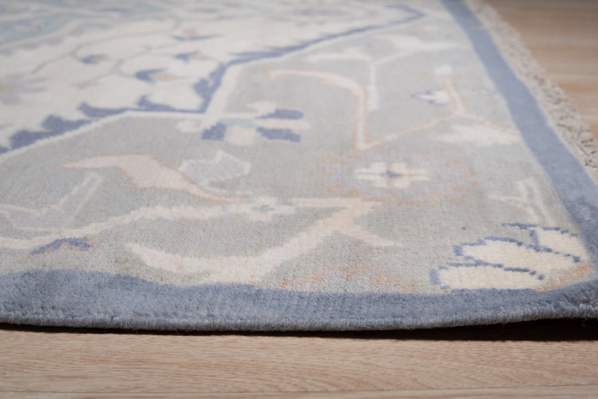 Stylish Trendy Ivory Hand Knotted Wool Rug, its soft ivory tones and intricate hand-knotted texture creating a welcoming ambiance in a modern living space.