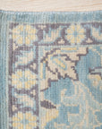 Bianca Oriental Ivory Hand Knotted Wool Rug displayed in a bright, modern living room. Its intricate, hand-knotted pattern adds warmth and texture to the space.