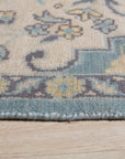 Bianca Oriental Ivory Hand Knotted Wool Rug, a plush ivory wool rug with intricate traditional patterns, displayed in a well-lit room.