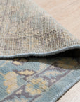 Bianca Oriental Ivory Hand Knotted Wool Rug, showcasing its intricate design and plush texture in a softly lit living room setting.