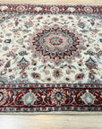 Timeless Cozy Ivory Hand Knotted Wool & Silk Rug, plush pile visible, subtly textured surface catching the light in a warm, inviting interior setting.