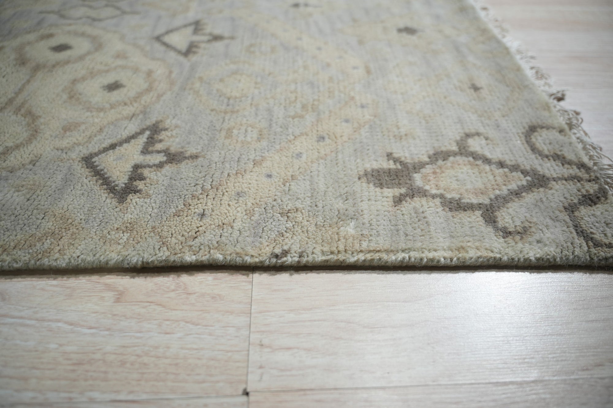 Lush Traditional Gray Hand Knotted Wool Rug, showcasing intricate traditional patterns in calming grays, bringing soft texture and subtle elegance to a well-lit living space.