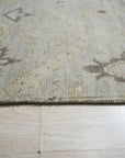 Lush Traditional Gray Hand Knotted Wool Rug, showcasing intricate traditional patterns in calming grays, bringing soft texture and subtle elegance to a well-lit living space.