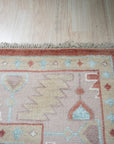 Penelope Traditional Rust Hand Knotted Wool Rug, its rich rust hues and intricate traditional patterns grounding a warmly lit living space.