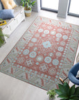 Penelope Traditional Rust Hand Knotted Wool Rug, displaying its rich rust hues and intricate traditional patterns in a warm, inviting living space. Hand-knotted construction highlights the rug's luxurious texture and detailed design.