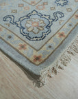 Captivating Timeless Light Blue Hand Knotted Wool Rug, soft light blue wool rug featuring a subtle, traditional pattern, seen in a bright, airy room.