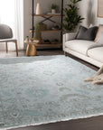 Classic Tessa Beige Nan Rug, neutral-toned floor covering with a subtly patterned design, displayed in a living room setting with furniture creating a cozy, inviting atmosphere.