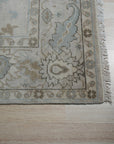 Classic Tessa Beige Nan Rug, a subtle, textured rug with a low pile construction, displayed in a warmly lit interior setting with contemporary furniture.