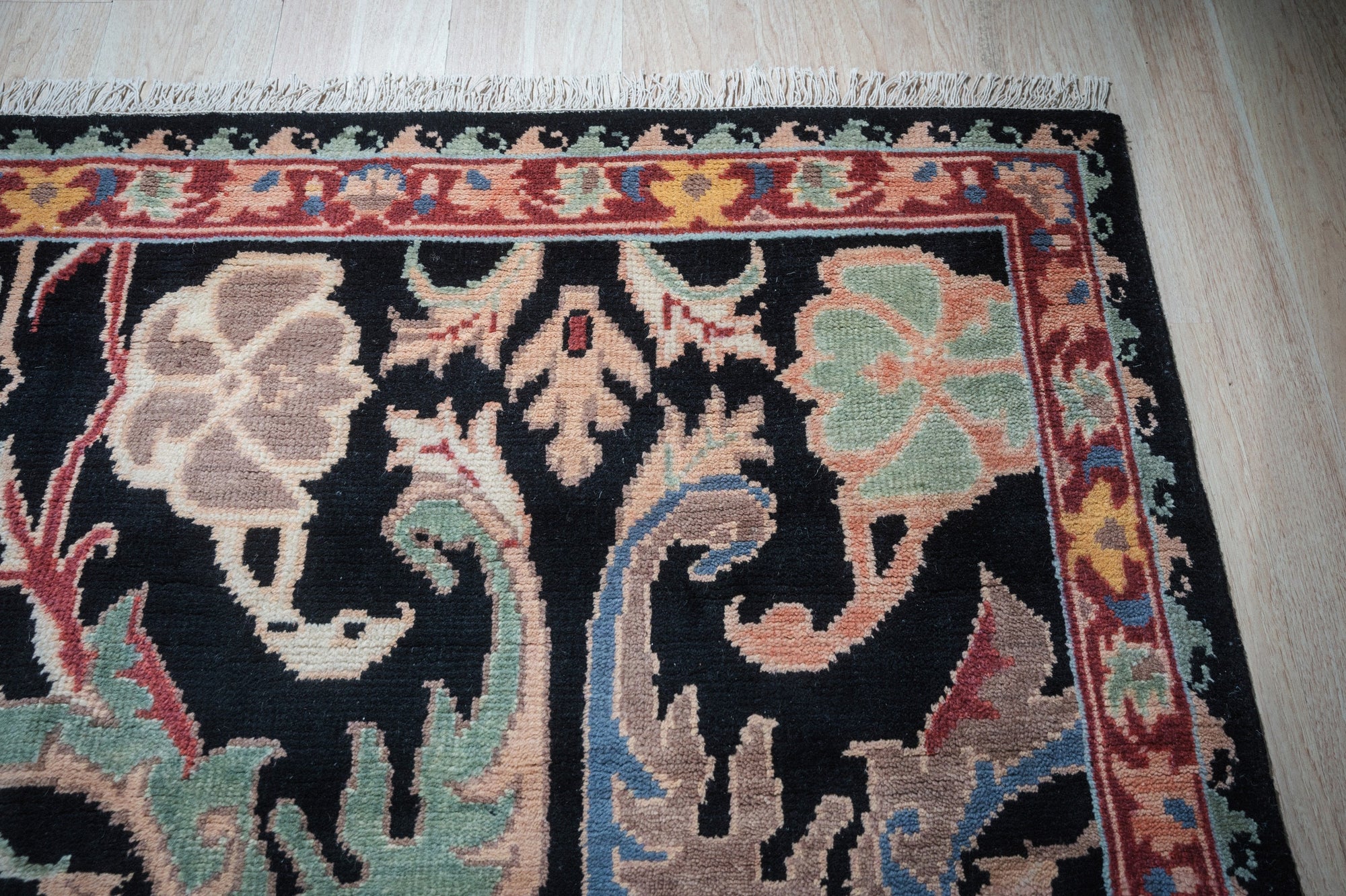 Sophisticated Timeless Black Hand-Knotted Wool Rug, showcasing intricate hand-knotted details and deep black tones, enriching a softly lit living space.