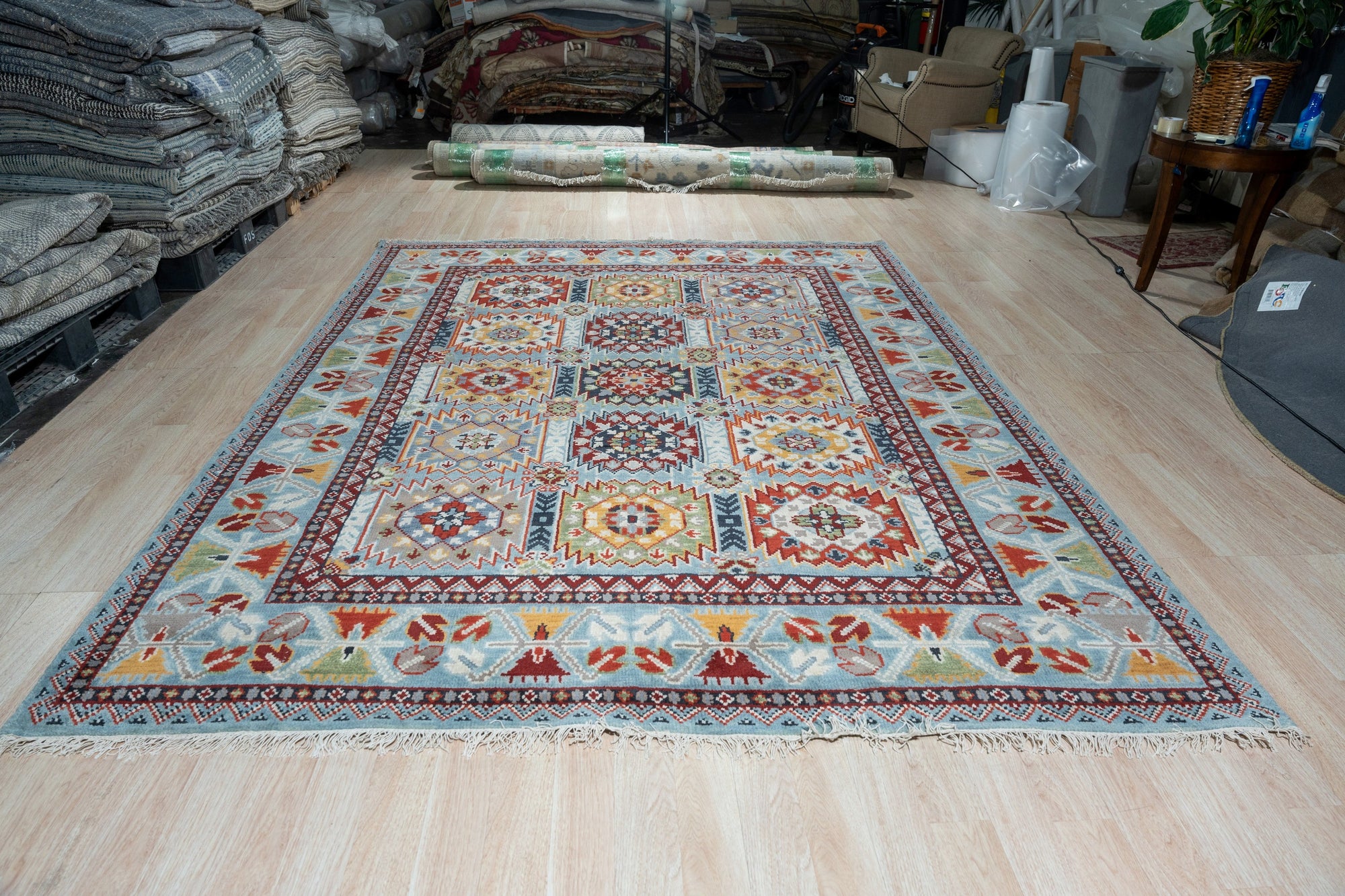 Modern Stylish Blue Hand-Knotted Wool Rug, showcasing its intricate geometric design in shades of blue and cream, laying flat to highlight the craftsmanship of hand-knotted wool.