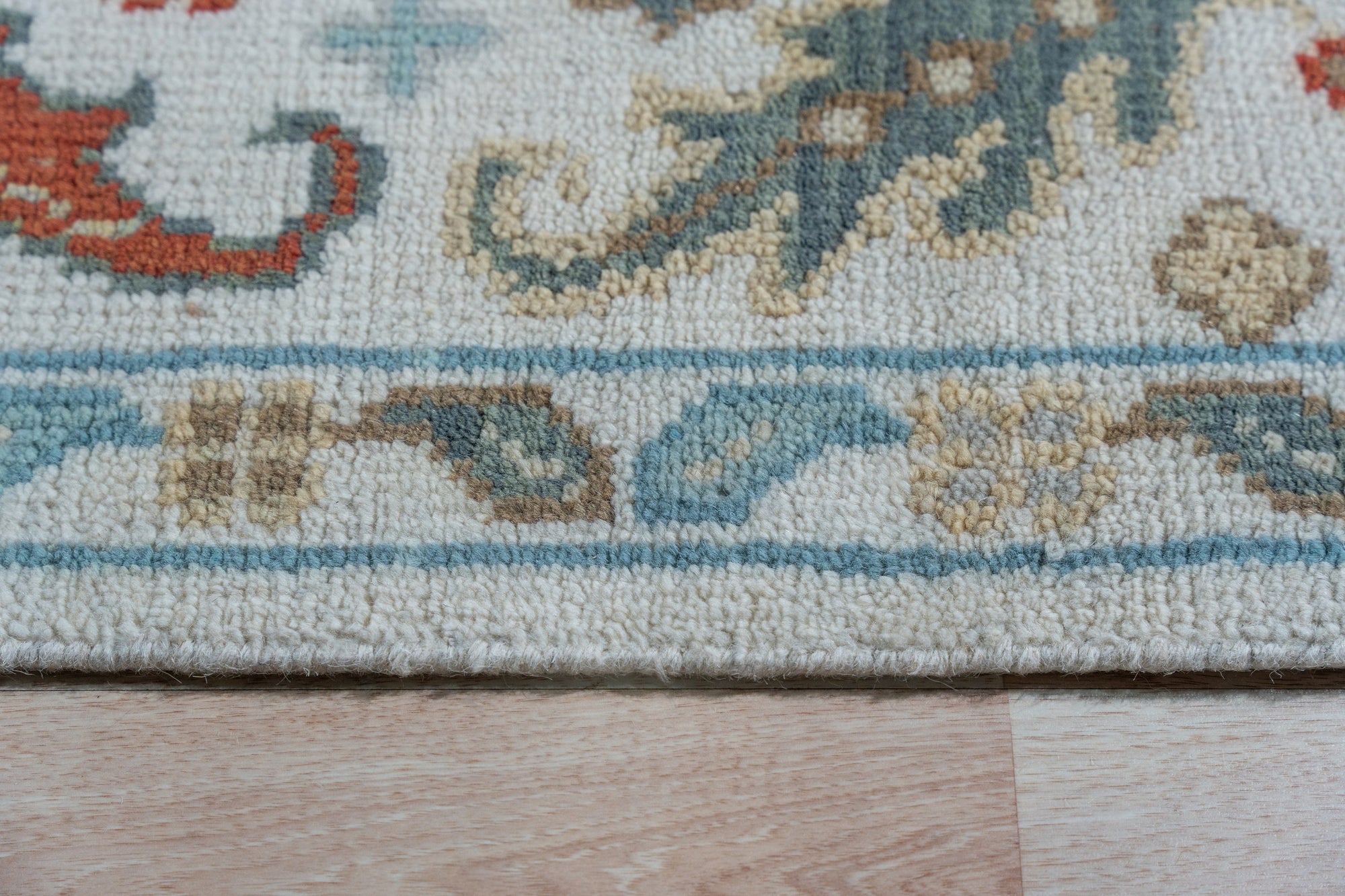 Stylish Sophisticated Beige Hand-Knotted Wool Rug, a warm beige wool rug with intricate hand-knotted detailing, enhancing a light-filled living room.