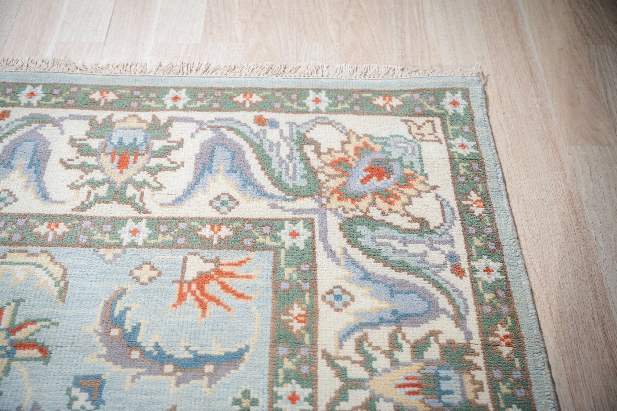 Stylish Elegant Blue Hand-Knotted Wool Rug, its intricate, hand-knotted construction evident in this detailed view, displays a rich blue palette and elegant design.