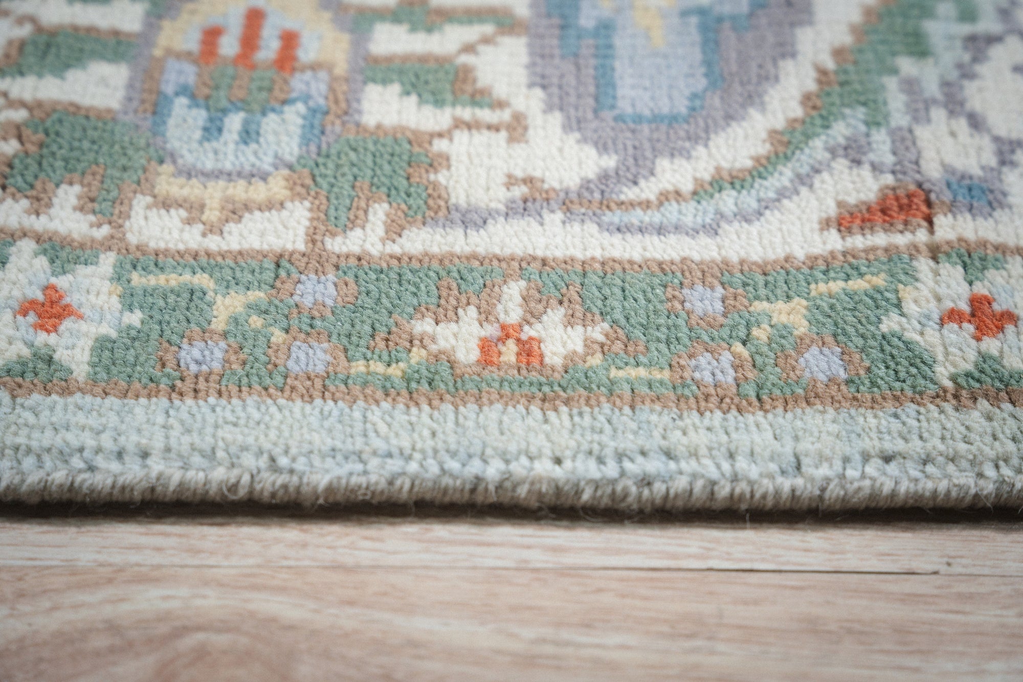 Stylish Elegant Blue Hand-Knotted Wool Rug, a vibrant blue wool rug with a detailed, traditional design, bathed in soft light that highlights its intricate hand-knotted construction.