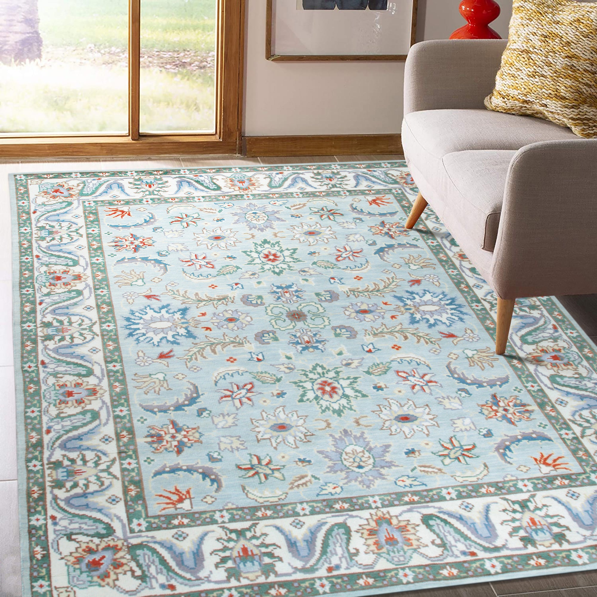 Stylish Elegant Blue Hand-Knotted Wool Rug, its intricate pattern in shades of blue and ivory drawing the eye within a bright, modern living space.