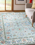 Stylish Elegant Blue Hand-Knotted Wool Rug, its intricate pattern in shades of blue and ivory drawing the eye within a bright, modern living space.