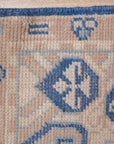Bespoke Oriental Blue Hand Knotted Wool Rug, its intricate floral and geometric motifs rendered in shades of blue, cream, and hints of coral, filling a sunlit living space with warmth and pattern.