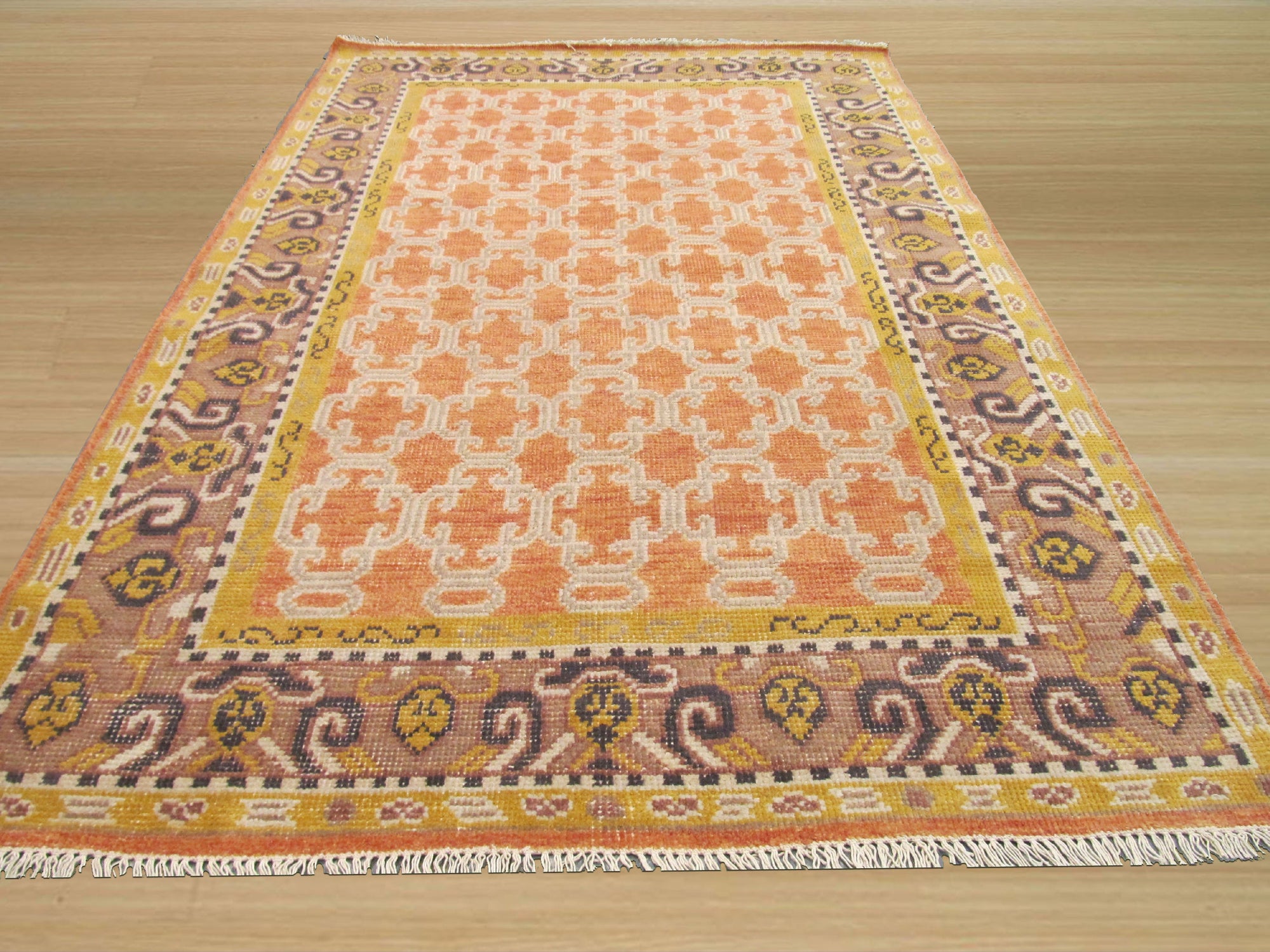 Jade Oriental Rust Hand Knotted Wool Rug, a richly textured wool rug featuring a vibrant rust palette and intricate oriental design, displayed in a room setting, highlighting its warm tones and hand-knotted construction.