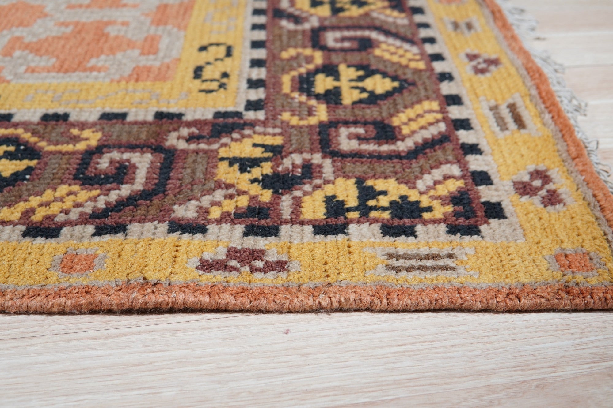 Jade Oriental Rust Hand Knotted Wool Rug, its intricate floral patterns and warm rust hues displayed, grounding a modern living space with traditional elegance.