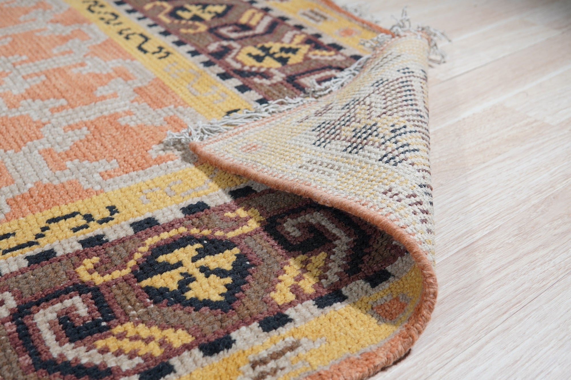 Jade Oriental Rust Hand Knotted Wool Rug, a richly colored wool rug with intricate oriental patterns, displayed in a brightly lit room setting.