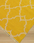 Xena Timeless Yellow Hand Knotted Rug, a warm yellow rug with subtle, intricate patterns, displayed within a bright, modern living space.