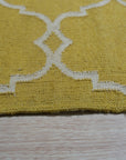 Xena Timeless Yellow Hand Knotted Rug, bathing a living room in warm yellow hues with its intricate hand-knotted design, rests under a modern coffee table, creating an inviting and stylish space.