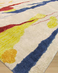 Ophelia Radiant Multicolor Hand Tufted Rug displayed in a bright, modern living room setting; vibrant hues and soft textures complement minimalist furniture, showcasing the rug's hand-tufted construction and radiant design.