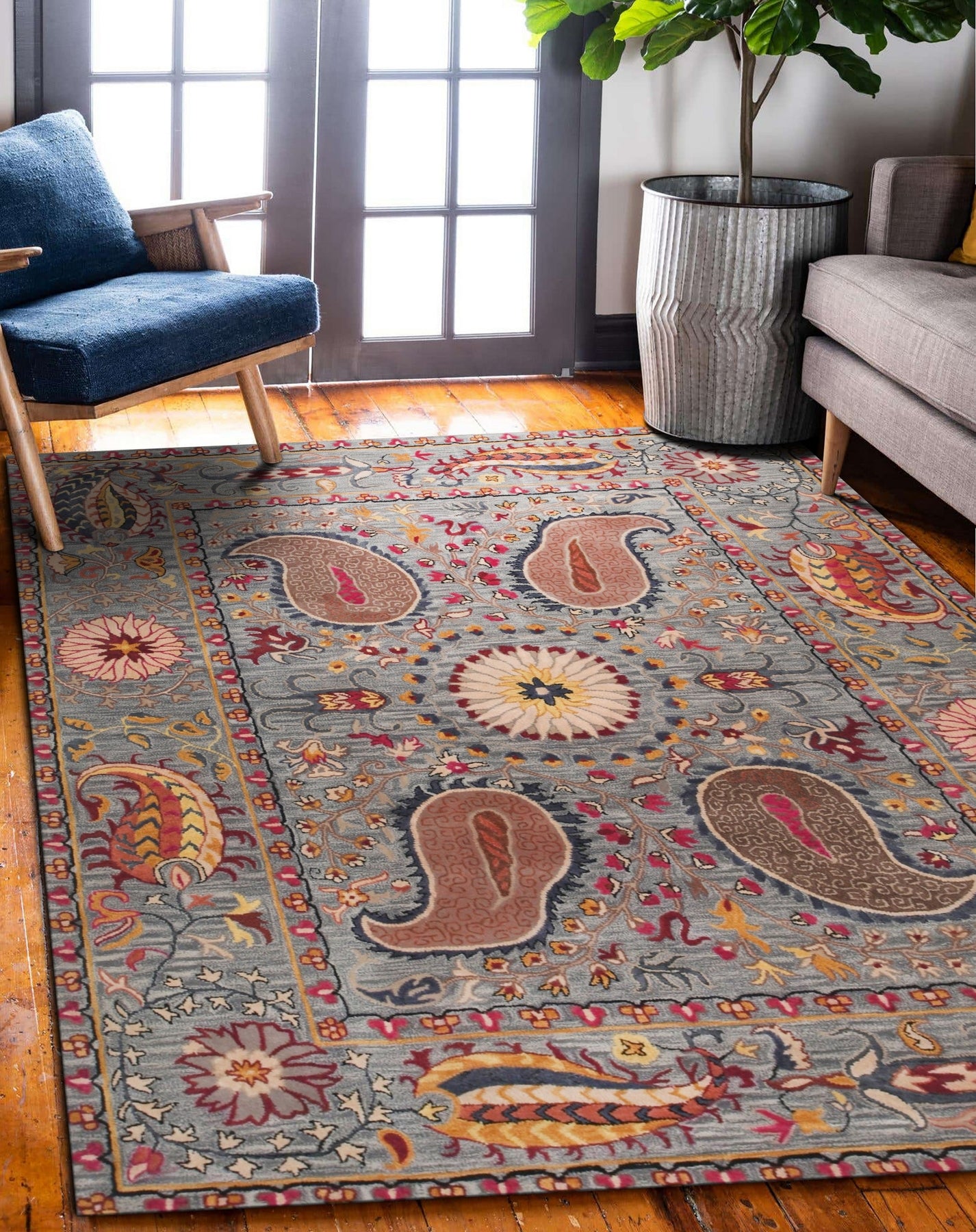 Maya Timeless Blue Hand Tufted Wool Rug, a captivating floor covering with subtle, textured patterns and cool blue tones, anchors a modern living room with neutral furniture and warm wood accents.
