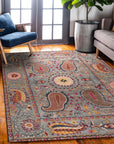 Maya Timeless Blue Hand Tufted Wool Rug, a captivating floor covering with subtle, textured patterns and cool blue tones, anchors a modern living room with neutral furniture and warm wood accents.