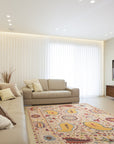 Chic Delicate Ivory Hand Tufted Wool Rug, seen under a modern grey sofa with patterned throw pillows, its soft ivory pile adding warmth and texture to the living room space.