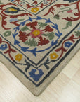 Ruby Fiona Ivory Hand Tufted Wool Rug, soft ivory wool rug with a subtle, geometric pattern, rests invitingly on a light hardwood floor, suggesting warmth and understated elegance.