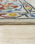 Ruby Fiona Ivory Hand Tufted Wool Rug, a soft ivory wool rug with a subtle, textured design, displayed in a bright, modern living room setting.