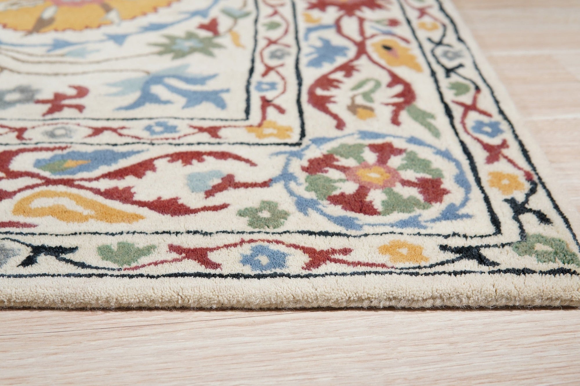 Ruby Fiona Ivory Hand Tufted Wool Rug, showcasing subtle textures and an elegant ivory palette, subtly grounded in a minimalist modern living space.