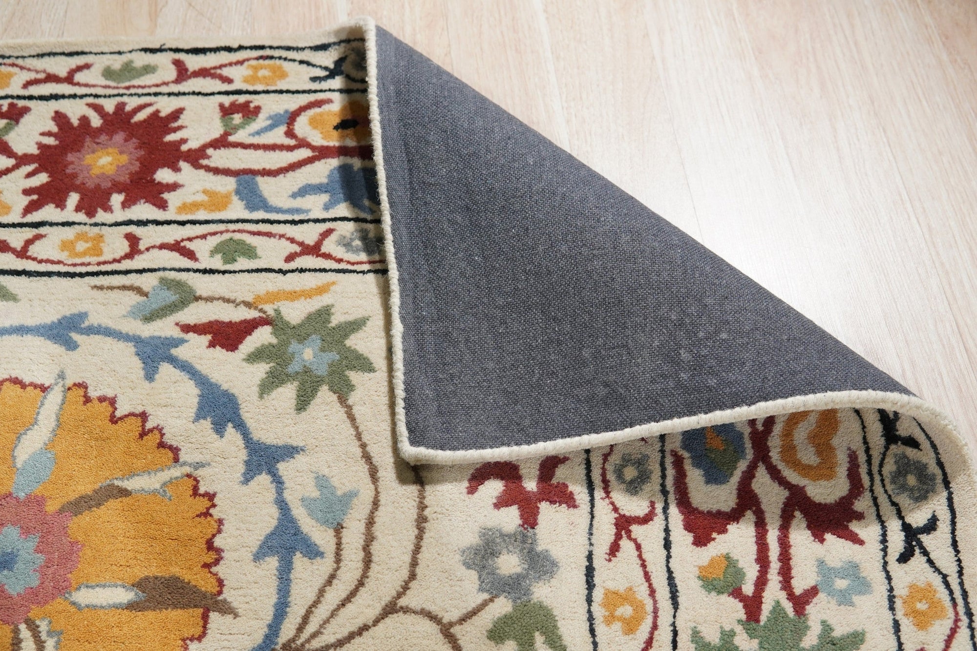 Ruby Fiona Ivory Hand Tufted Wool Rug, showcasing a textured ivory surface with subtle, abstract patterns, hand-tufted for luxurious feel and visual depth.