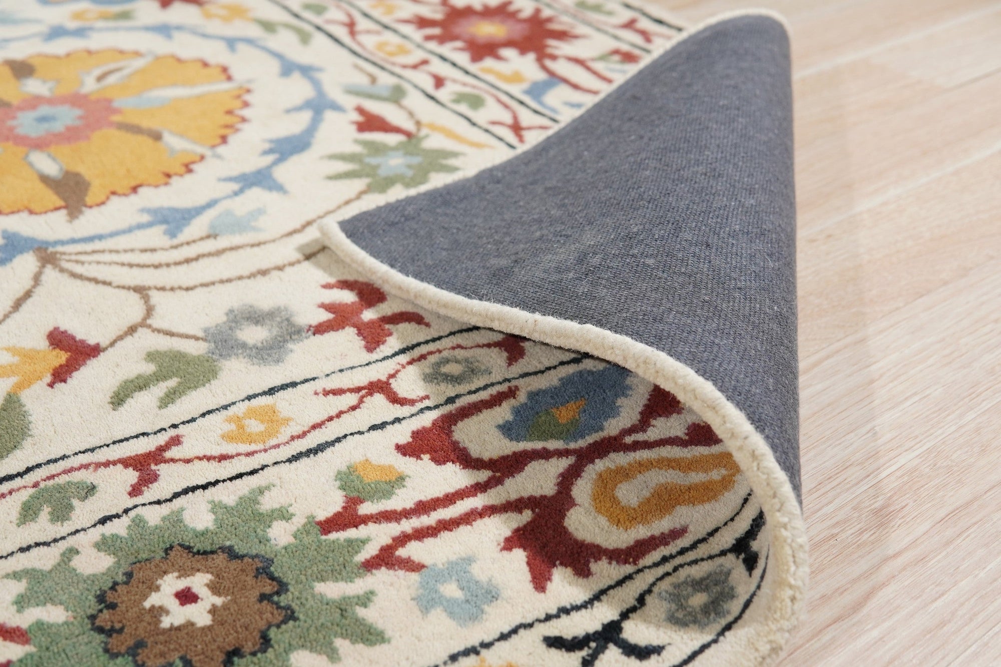 Ruby Fiona Ivory Hand Tufted Wool Rug, soft ivory wool pile inviting touch, showcasing its subtle texture within a living room setting.