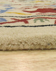 Ruby Fiona Ivory Hand Tufted Wool Rug, features a subtle, textured design in soft ivory tones, its hand-tufted wool construction adding a plush and inviting element to a room setting.
