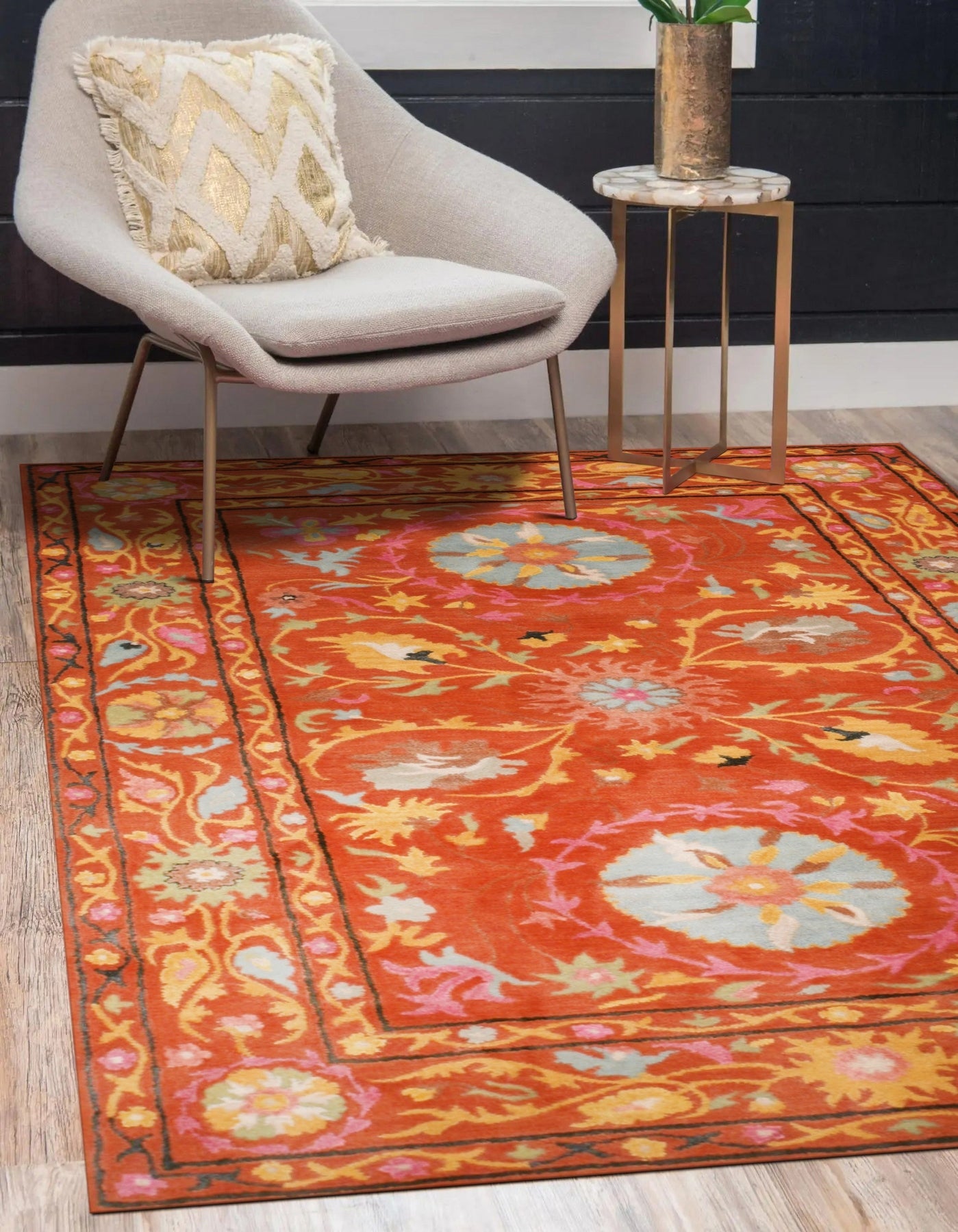 Willow Jade Rust Hand Tufted Wool Rug, a blend of jade green, rust, and cream hues, seen in a living room setting with mid-century modern furniture.