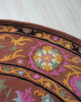 Willow Jade Rust Hand Tufted Wool Rug, its warm rust tones and soft jade accents lending an earthy elegance to a well-lit living space.