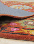 Willow Jade Rust Hand Tufted Wool Rug, showcasing earthy jade and rust tones in a hand-tufted construction, providing a touch of warmth and texture to a room setting.