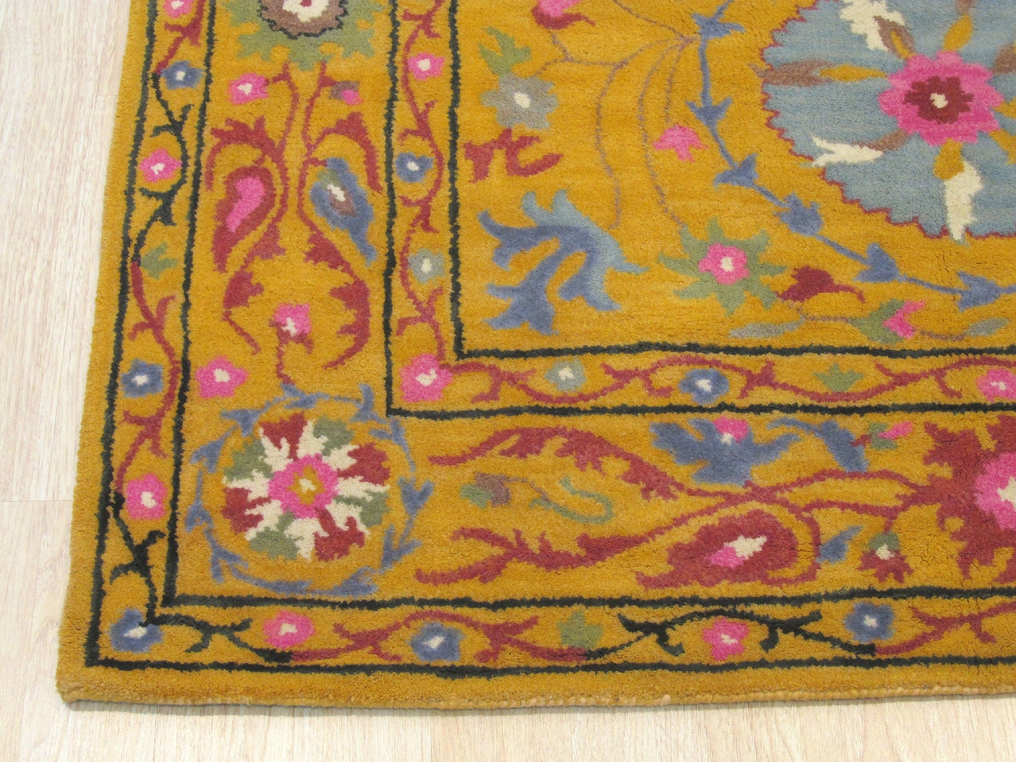 Violet Ruby Yellow Hand Tufted Wool Rug, its vibrant violet, ruby, and yellow hues creating a striking pattern, displayed in a modern living space.