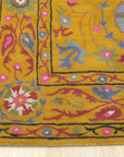 Violet Ruby Yellow Hand Tufted Wool Rug, its vibrant violet, ruby, and yellow hues creating a striking pattern, displayed in a modern living space.