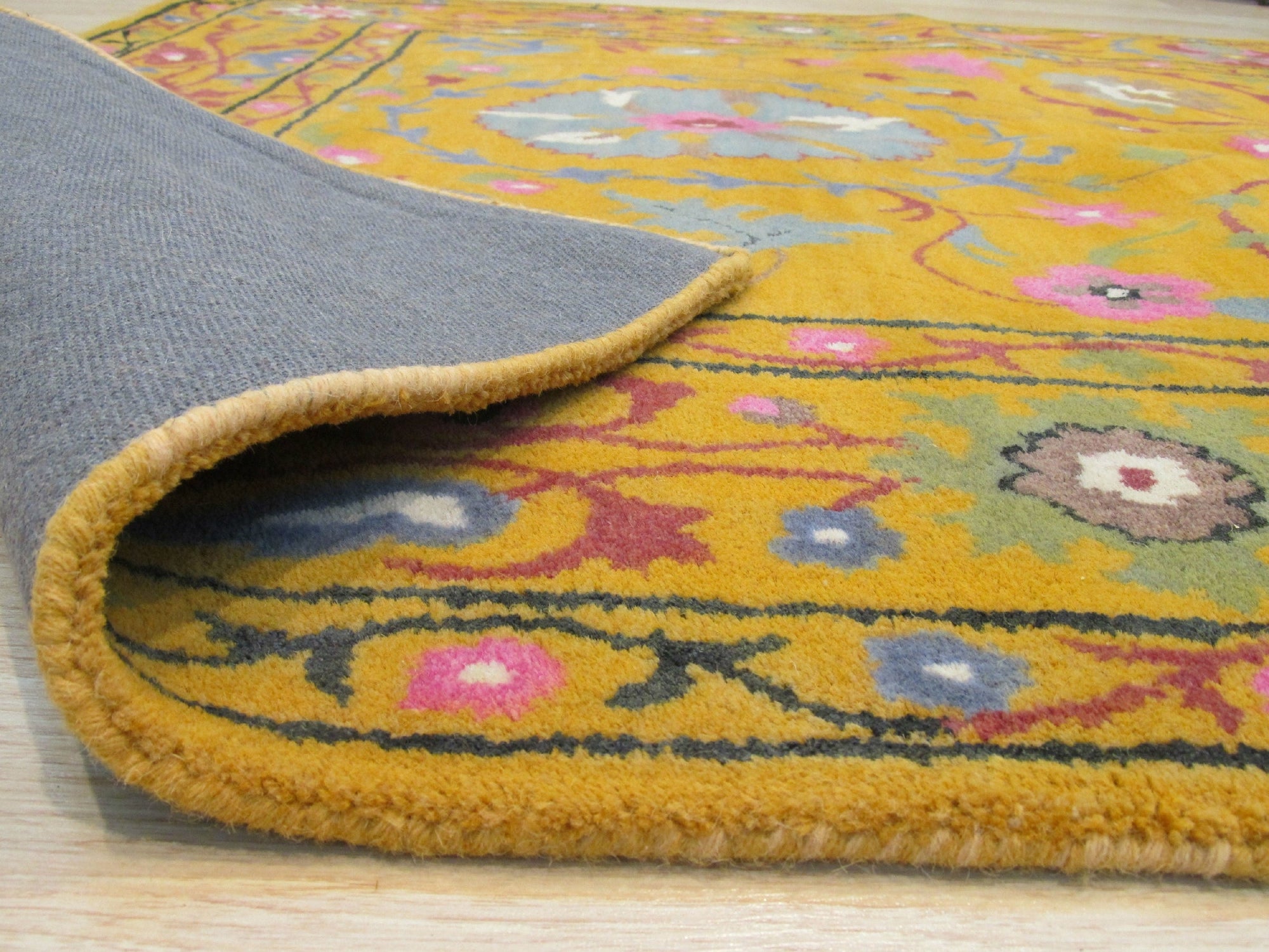Violet Ruby Yellow Hand Tufted Wool Rug, displaying a dynamic blend of violet, ruby, and yellow hues in a hand-tufted construction, fills the room with warmth and texture.