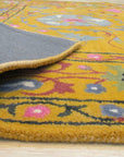 Violet Ruby Yellow Hand Tufted Wool Rug, displaying a dynamic blend of violet, ruby, and yellow hues in a hand-tufted construction, fills the room with warmth and texture.