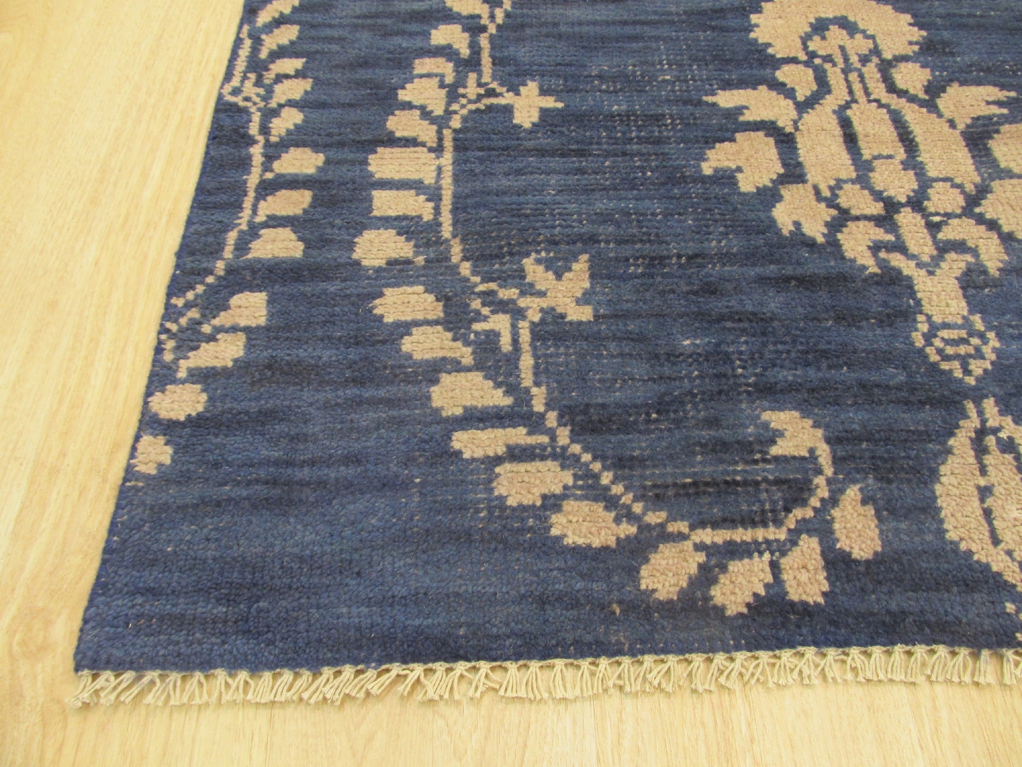 Luxurious Chloe Blue Hand Knotted Wool Rug, its cool blue tones and intricate hand-knotted detail softening a contemporary living space.