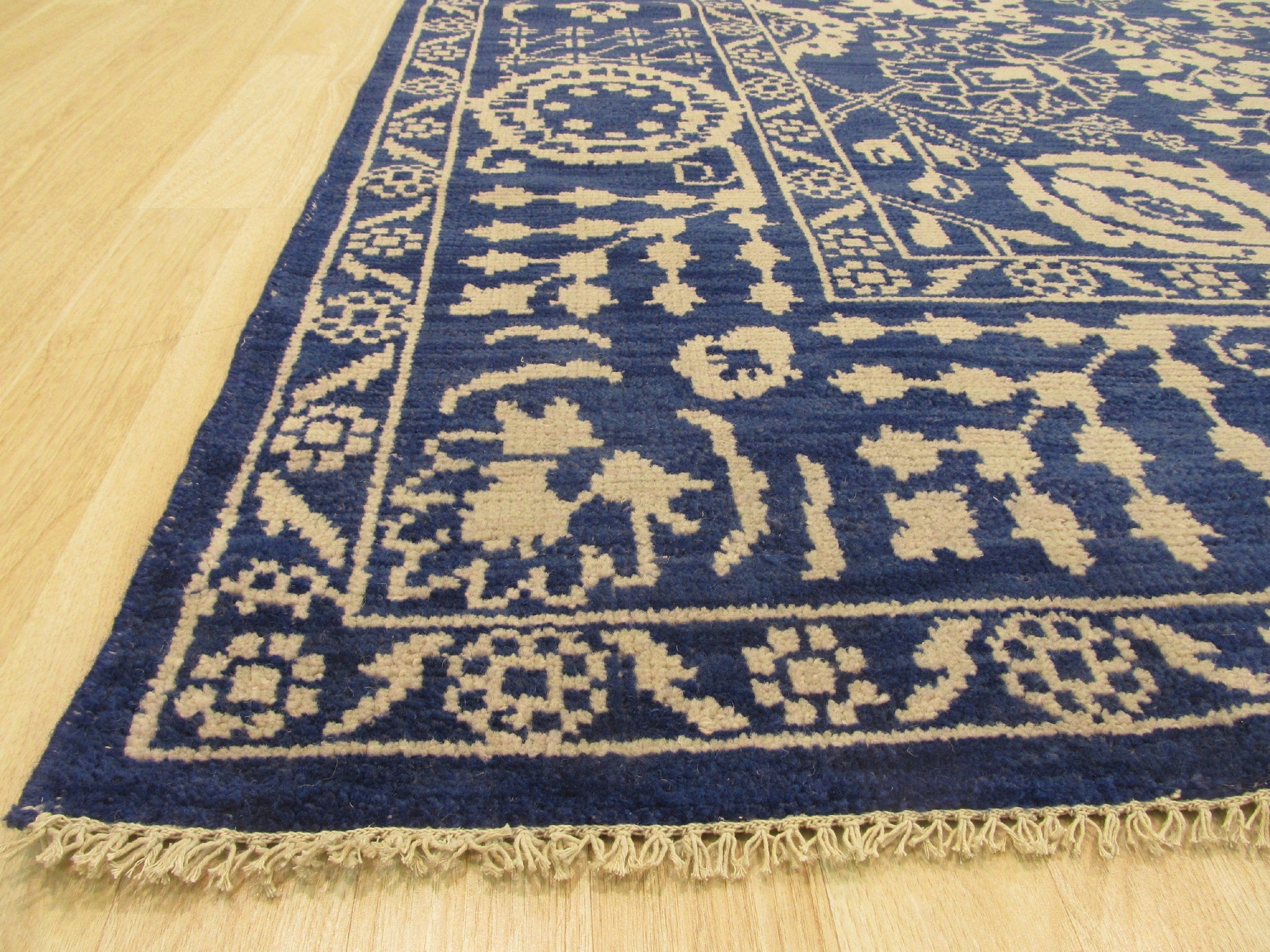 Alluring Freya Blue Hand Knotted Wool Rug, a vibrant blue and cream wool rug with an intricate, distressed pattern, seen in a well-lit living room setting.