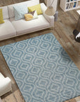 Louie Moroccan Aqua Hand Knotted Wool Rug, its textured wool and hand-knotted construction adding depth to a living space. Aqua hues and subtle geometric patterns create a serene atmosphere.