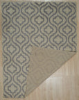 Rhea Moroccan Gray Hand Knotted Wool Rug displayed in a living room setting. Soft gray hues and hand-knotted wool construction enhance the rug's textured, geometric Moroccan-inspired design.